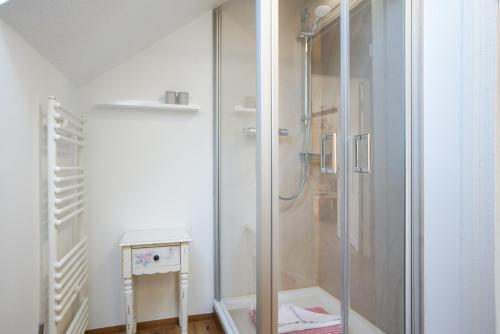 a shower with a glass door in a bathroom at Villa Harmonie - Apartment Jasmin in Borkum