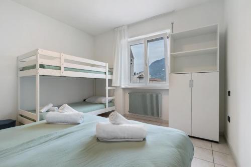 a bedroom with two bunk beds and a window at La casa di Romi in Mori