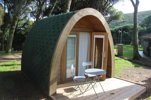 a small shed with a table and chairs in it at Montejunto Bungalows in Cadaval
