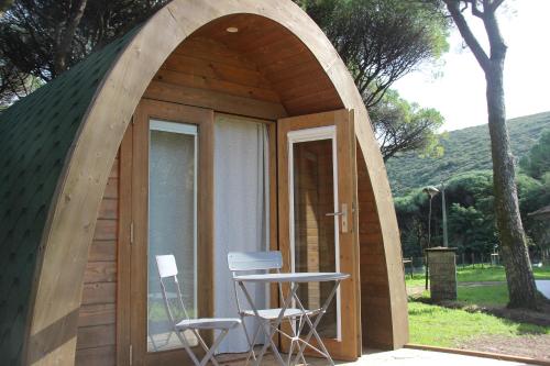 a small tent with two chairs and a table at Montejunto Bungalows in Cadaval