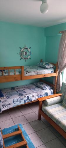 a room with two bunk beds and a couch at Afsaal 214 in Amanzimtoti