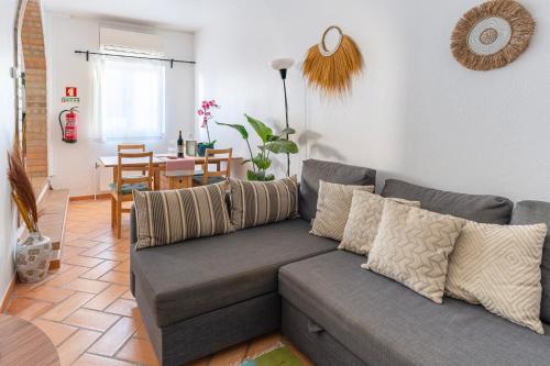 a living room with a couch and a dining room at Casa Oceano-Ave do Mar in Raposeira