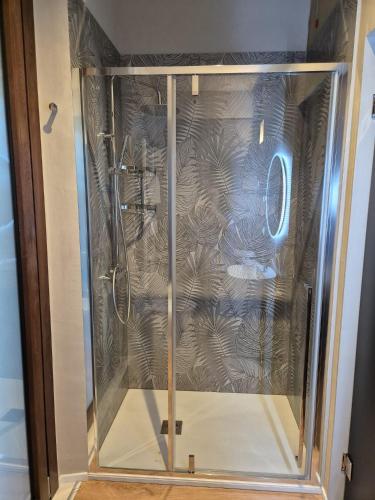 a shower with a glass door in a room at RiDi Home 466- Suite in centro a 5 minuti dal mare in Porto SantʼElpidio