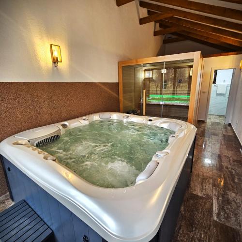 a large jacuzzi tub in a room at Pensiunea Casa-Stefanel in Sadova