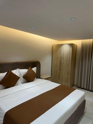 Ένα ή περισσότερα κρεβάτια σε δωμάτιο στο أوان ريزدنس Awan Residence