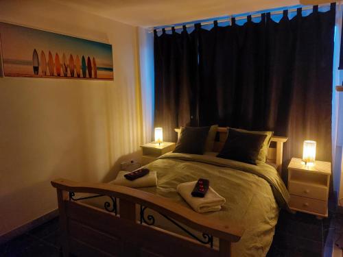 a bedroom with a bed with two towels and two lamps at Beautiful small Apartment El silencio in Zürich