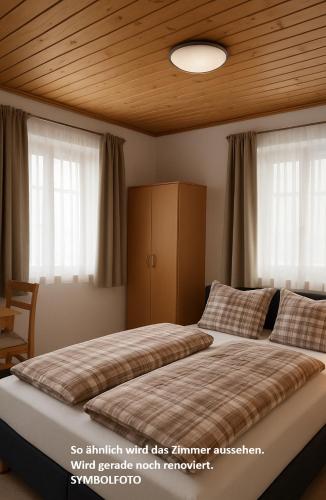 a bedroom with a large bed with a wooden ceiling at Burgfräulein in Hardegg