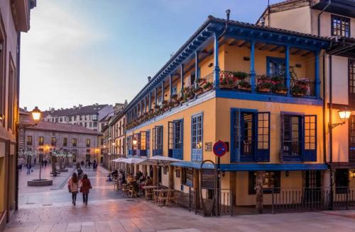 a group of people walking down a street at Apartamentos Marques de Teverga , Oviedo centro in Oviedo