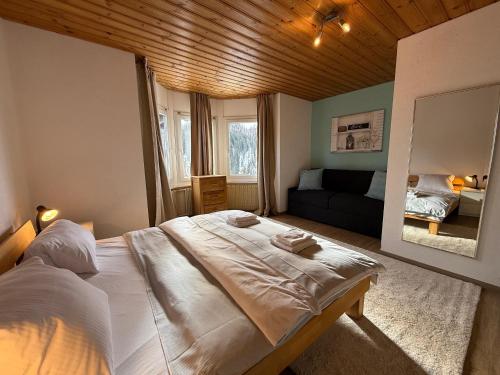 a bedroom with a large bed and a living room at Miraflor Carmen - Arosa Holiday in Arosa