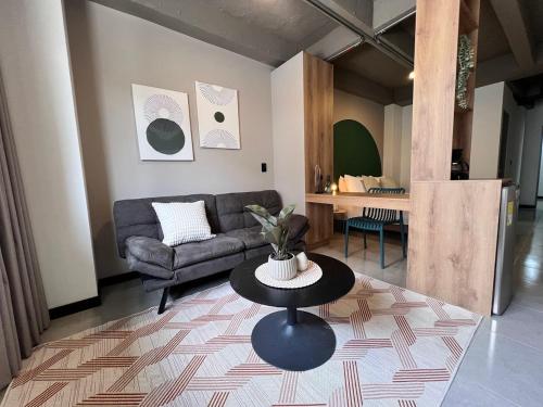 a living room with a couch and a table at Moore 45 Tu Espacio Comodo en Medellín in Medellín