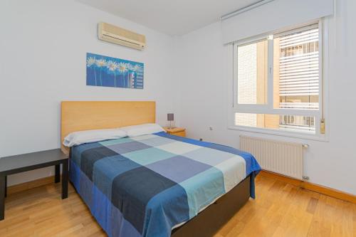 a bedroom with a bed and a desk and a window at APARTAMENTO EN MADRID CENTRO comodo in Madrid