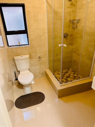een badkamer met een toilet en een douche bij 12th on The Bay in Richards Bay