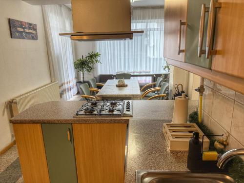 a kitchen with a stove and a counter top at Márta Vendégház in Gyenesdiás