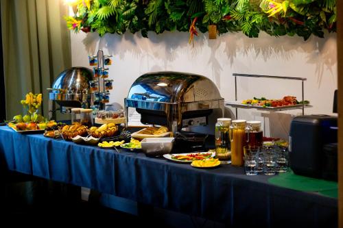 a buffet of food on a blue table at Aparthotel Green Concrete - Free Beach Bus in Świnoujście