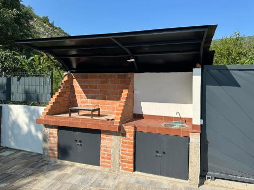 a patio with a brick oven with a bench on it at Villa Sale Buna in Mostar