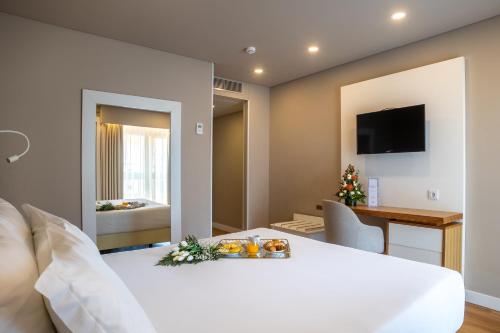 Ένα ή περισσότερα κρεβάτια σε δωμάτιο στο Hotel Cristal Caldas