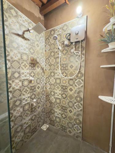 a shower with a shower head in a bathroom at Flexi Lodge in Negombo