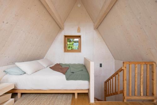 a bedroom with a bed in a attic at Il Pino in Tarvisio