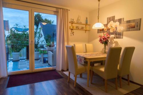 a dining room with a table and chairs and a window at Golf Oase in Lebbin