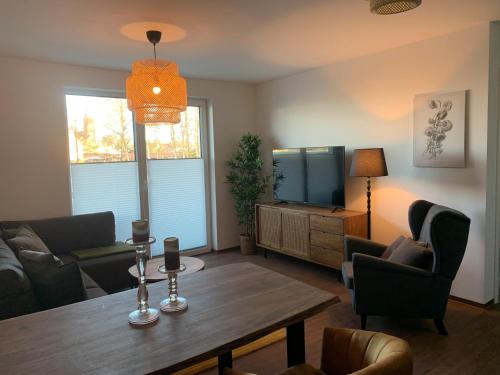 a living room with a table and a tv at Am Hafen 15 in Röbel