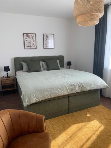 a bedroom with a bed and a chair in it at Am Hafen 15 in Röbel