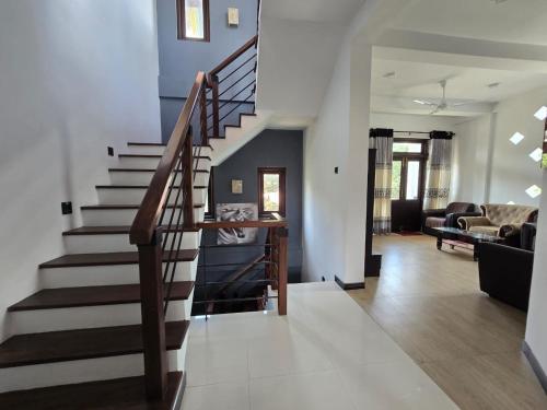 a staircase in a house with a living room at Villa Bloomscape in Galle