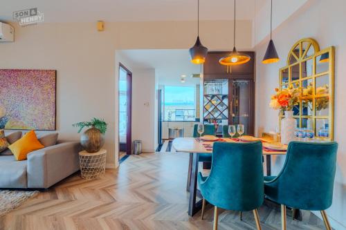 a living room with a table and chairs and a couch at Son&Henry Sailing Tower in Ho Chi Minh City