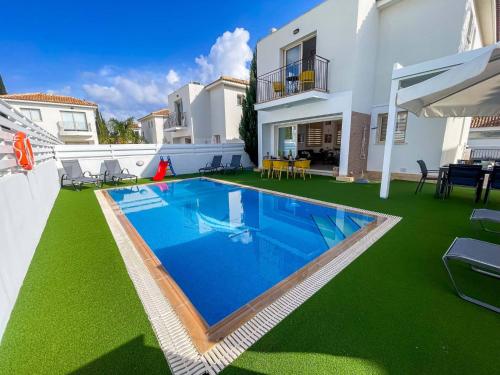 a swimming pool in the backyard of a house at Villa Allegra in Protaras