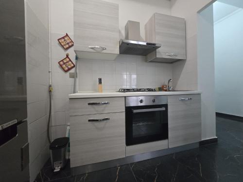 a kitchen with a stove top oven in a room at RENT IN MILAN bilocale di 40 mq con parcheggio in Milan