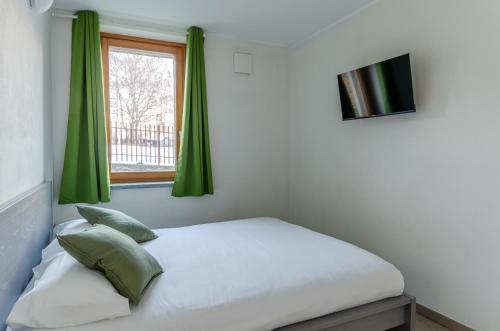 En eller flere senge i et værelse på Aosta Holiday Apartments - Charvensod