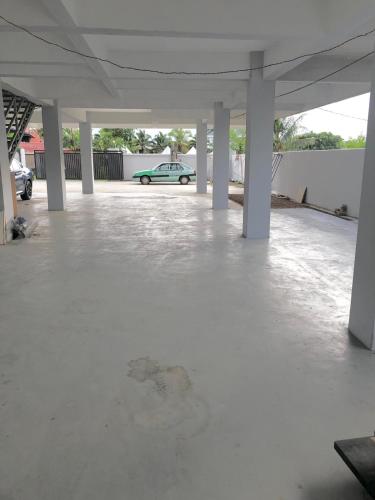 un parking vide avec une voiture en arrière-plan dans l'établissement JR Residence, à Kota Kinabalu