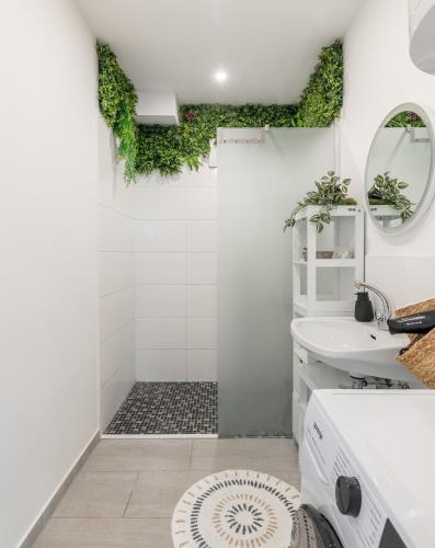 a bathroom with a shower and a sink at GreenSide ThermenSuite Frauenkirchen in Frauenkirchen