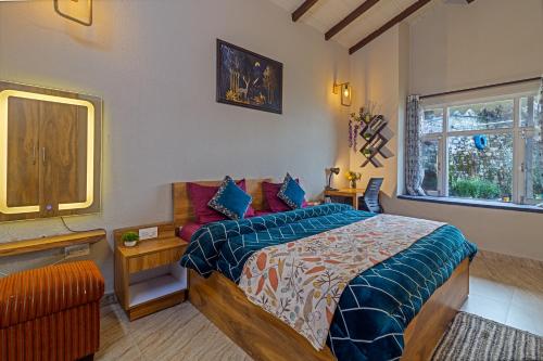 a bedroom with a bed and a window at Villa KAILASA in Mukteshwar