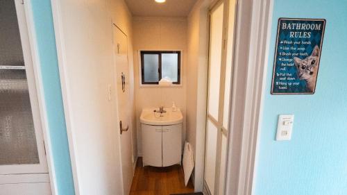 a small bathroom with a sink and a toilet at 佐世保まち宿 in Sasebo