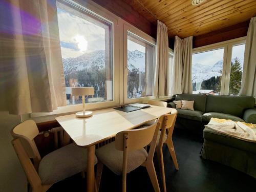 a living room with a table and chairs and a couch at Miraflor Sonja by Arosa Holiday in Arosa