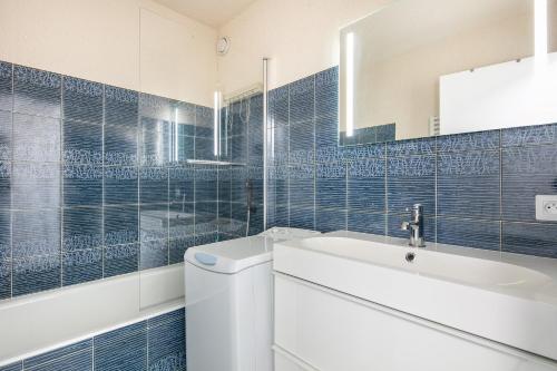 a bathroom with a toilet and a sink and a mirror at Les Crocus - Magnifique Vue Montagne in Comboursière