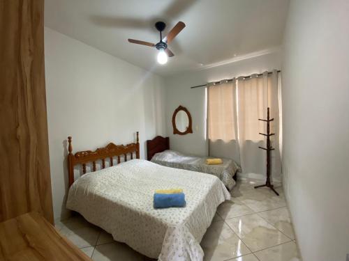 皮乌米Casa no Centro de Piumhi的一间带两张床和吊扇的卧室