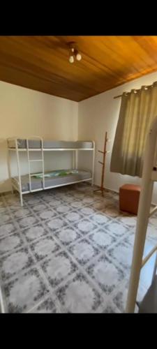 a room with a bed and a tiled floor at Fazenda Torrão da Serra in Guarulhos