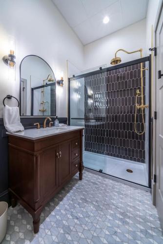 a bathroom with a sink and a shower at The Plum Suite in Sedalia