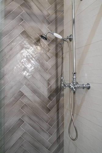 a shower with a shower head in a bathroom at The Library in Sedalia