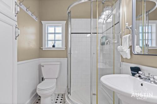 a bathroom with a toilet and a sink and a shower at East Austin 2BR 1BA w Patio and Grill, Pet-Friendl Walk to 6th By Austin Vacay in Austin