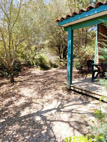 a gazebo with a bench sitting on a porch at Chalet 1 in Cazilhac