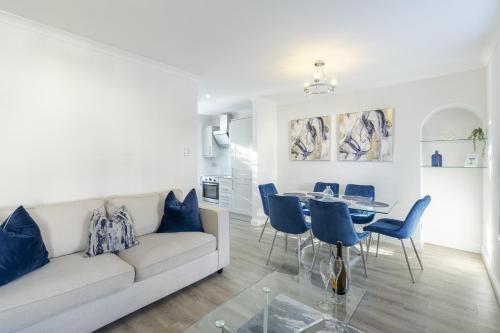 a living room with a couch and a table and chairs at Casa Fresa - 224 King St in Broughty Ferry