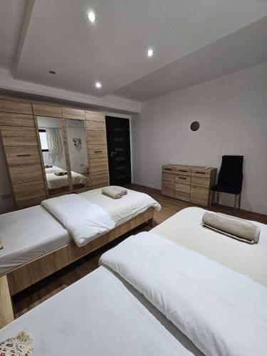 a bedroom with two beds and a chair in it at Soulnest Peace bedroom in shared flat in Qbajjar