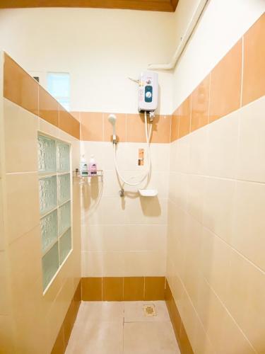 a bathroom with a shower with a sink at Na Soi 5 Chiangkhan in Chiang Khan