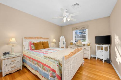 a bedroom with a bed and a ceiling fan at 350 School House Road Eastham - Beach Dreams in Eastham