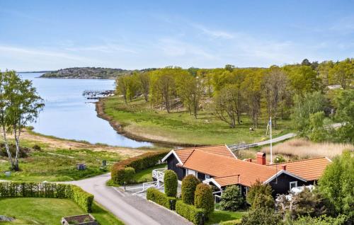 an aerial view of a house next to a lake at 5 Bedroom Cozy Home In Onsala in Draget