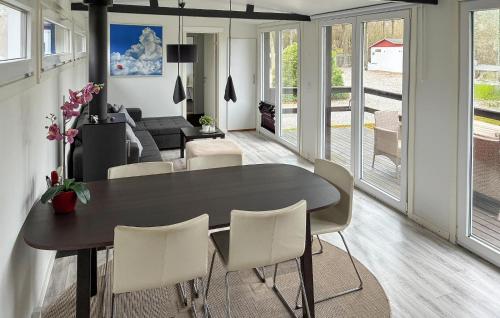 a dining room and living room with a table and chairs at 2 Bedroom Amazing Home In Samsø in Kolby Kås