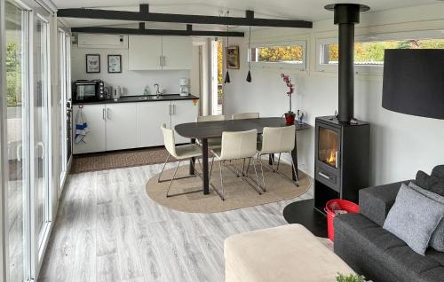 a kitchen and living room with a table and a stove at 2 Bedroom Amazing Home In Samsø in Kolby Kås