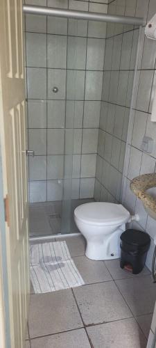 a bathroom with a toilet and a shower at Pousada Ouro de Minas Diamantina in Diamantina